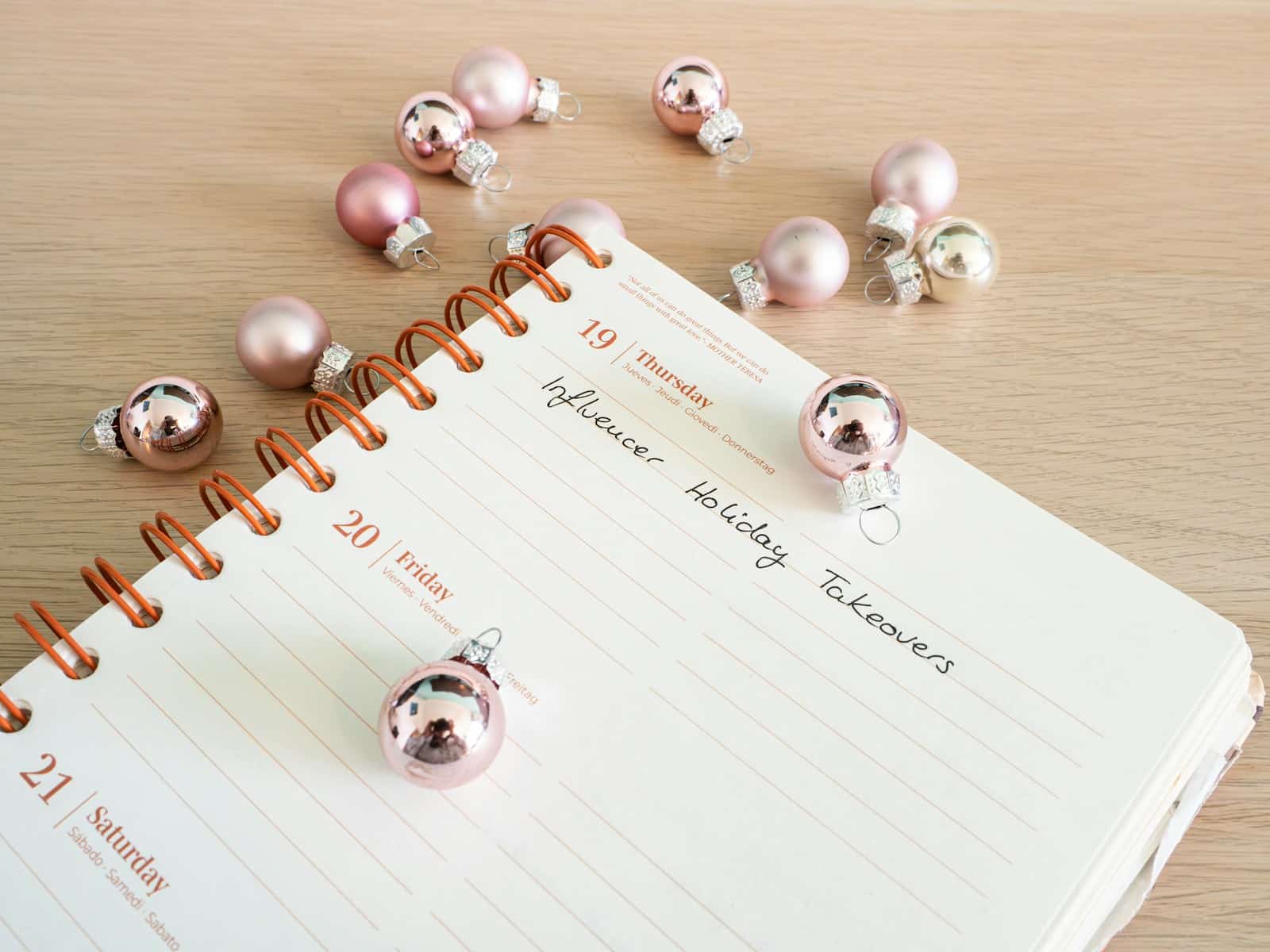 a notepad with a bunch of christmas ornaments on top of it